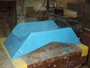 Sanding the carriage mount points so they are on a single plane. Click for enlargement.